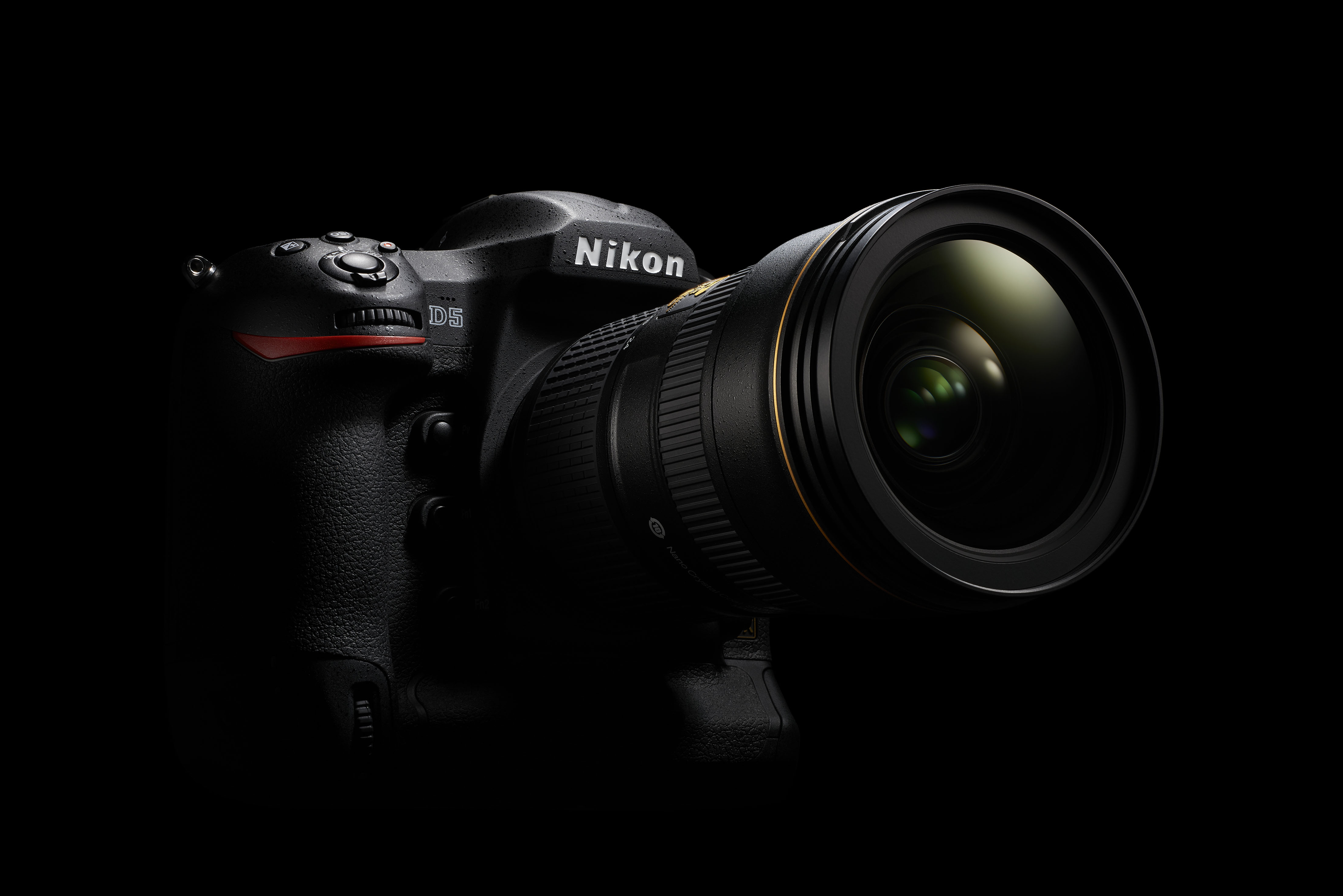 Nikon D5 in front of black background.